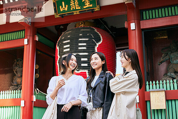 Japanese friends visiting traditional temple in Tokyo