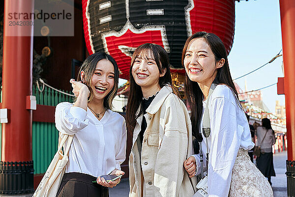 Japanese friends visiting traditional temple in Tokyo