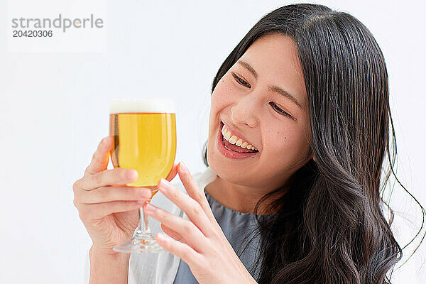 Japanese woman holding a glass of beer