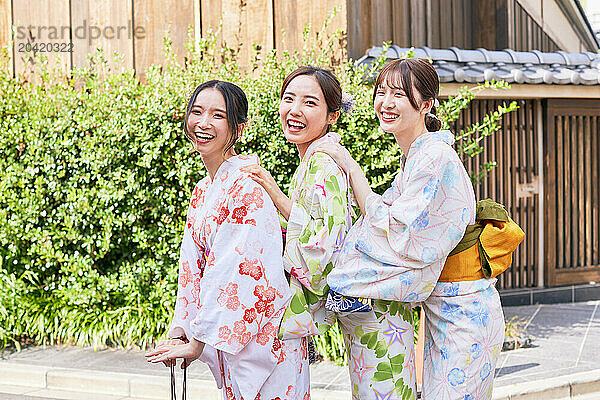 Japanese friends wearing yukata visiting traditional area in Tokyo