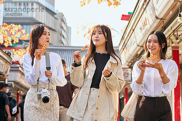 Japanese friends visiting traditional temple in Tokyo