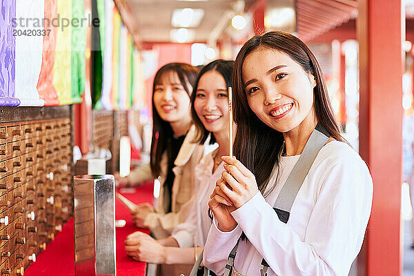 Japanese friends visiting traditional temple in Tokyo