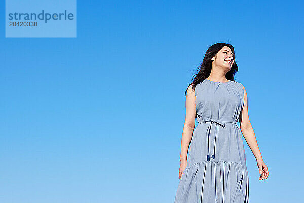 Japanese woman against blue sky