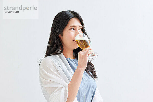 Japanese woman holding a glass of beer