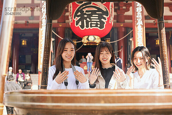 Japanese friends visiting traditional temple in Tokyo