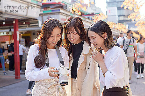 Japanese friends visiting traditional temple in Tokyo