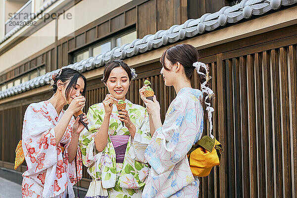 Japanese friends wearing yukata visiting traditional area in Tokyo