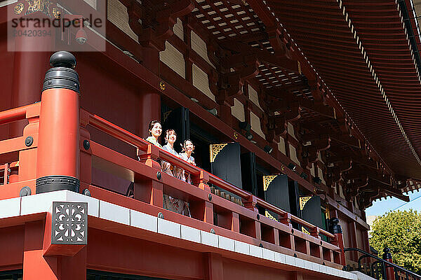 Japanese friends wearing yukata visiting traditional temple in Tokyo