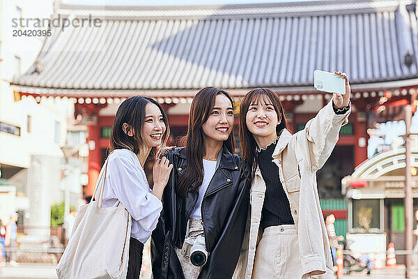 Japanese friends visiting traditional temple in Tokyo