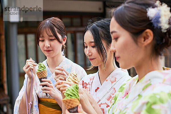 Japanese friends wearing yukata visiting traditional area in Tokyo