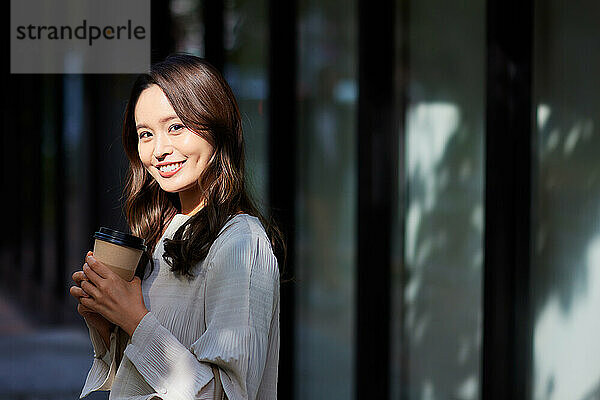 Japanese woman holding a coffee cup