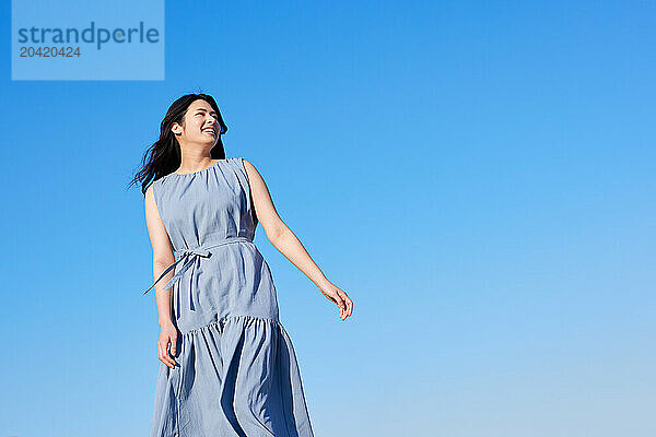 Japanese woman against blue sky