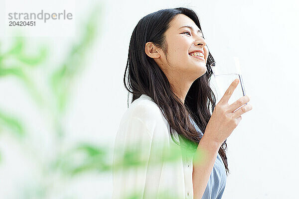 Japanese woman holding a glass of water