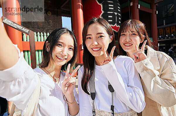 Japanese friends visiting traditional temple in Tokyo