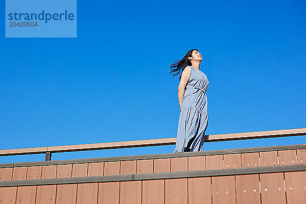 Japanese woman against blue sky