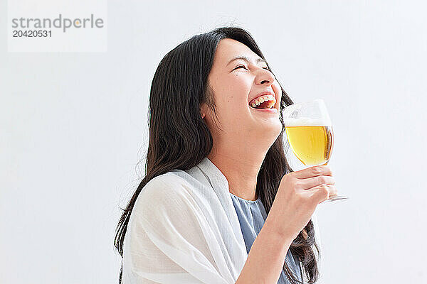 Japanese woman holding a glass of beer