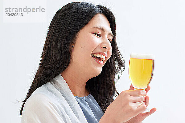 Japanese woman holding a glass of beer