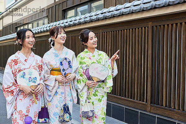 Japanese friends wearing yukata visiting traditional area in Tokyo