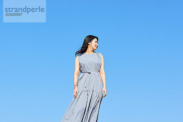 Japanese woman against blue sky