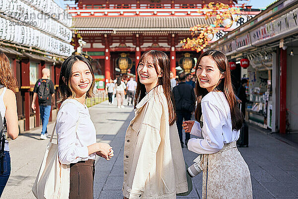 Japanese friends visiting traditional temple in Tokyo