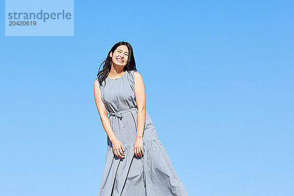 Japanese woman against blue sky