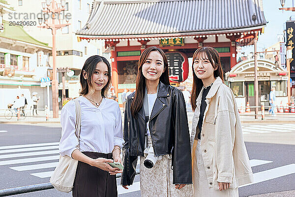 Japanese friends visiting traditional temple in Tokyo