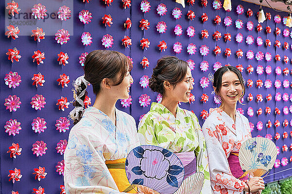 Japanese friends wearing yukata visiting traditional area in Tokyo