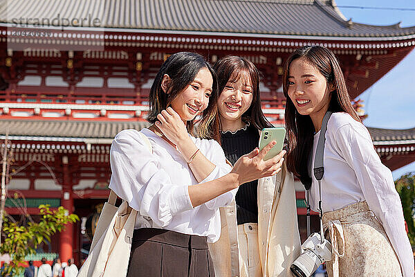 Japanese friends visiting traditional temple in Tokyo