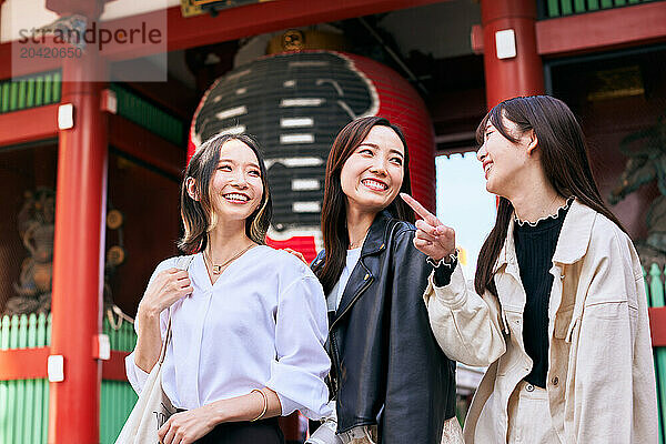 Japanese friends visiting traditional temple in Tokyo