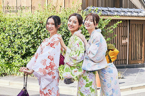 Japanese friends wearing yukata visiting traditional area in Tokyo