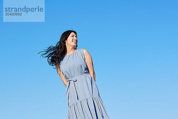 Japanese woman against blue sky