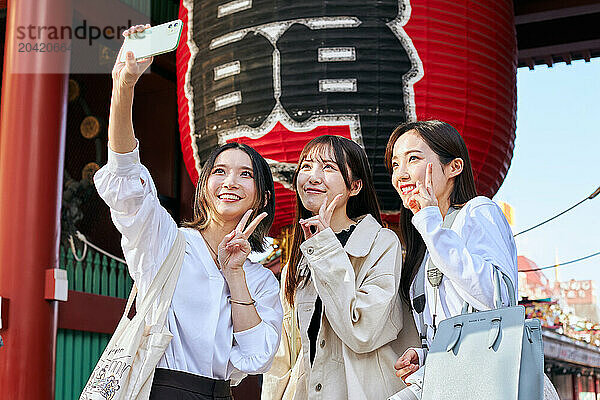 Japanese friends visiting traditional temple in Tokyo