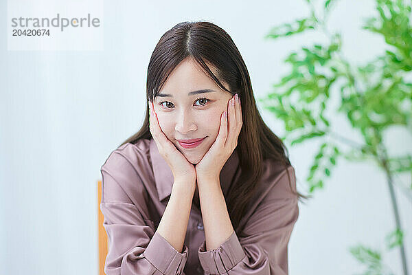 Japanese woman smiling while sitting at a table