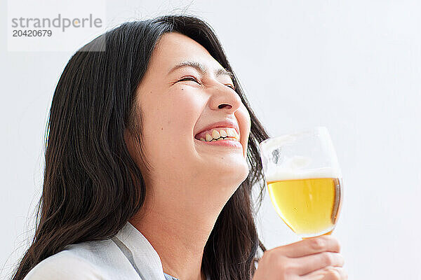 Japanese woman holding a glass of beer