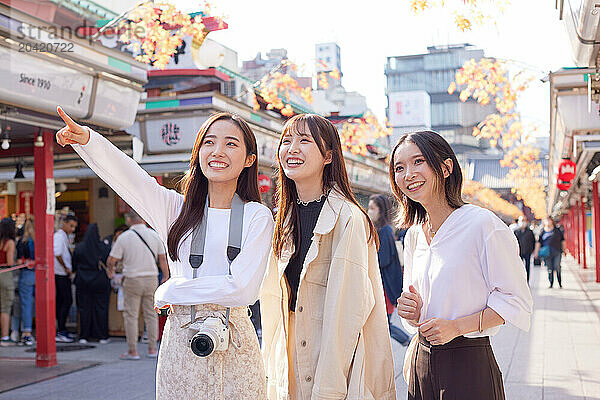 Japanese friends visiting traditional temple in Tokyo