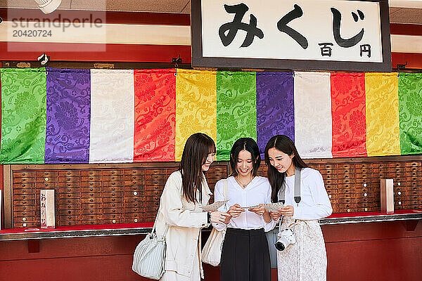 Japanese friends visiting traditional temple in Tokyo