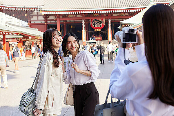 Japanese friends visiting traditional temple in Tokyo