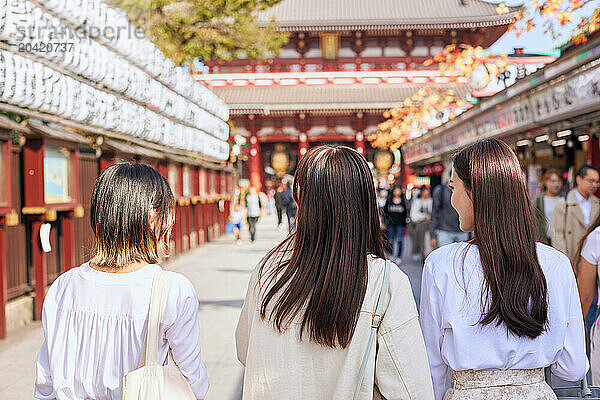 Japanese friends visiting traditional temple in Tokyo