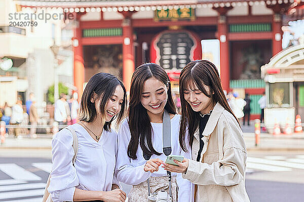 Japanese friends visiting traditional temple in Tokyo