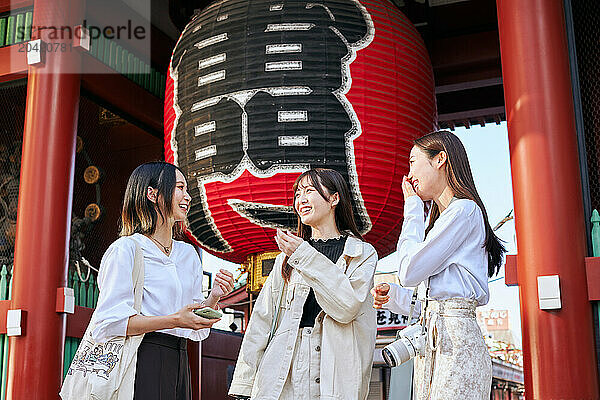 Japanese friends visiting traditional temple in Tokyo