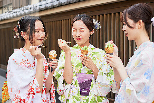 Japanese friends wearing yukata visiting traditional area in Tokyo