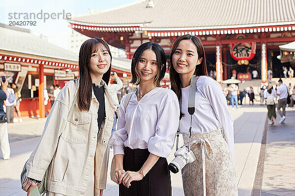 Japanese friends visiting traditional temple in Tokyo