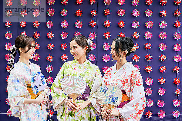 Japanese friends wearing yukata visiting traditional area in Tokyo