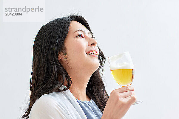 Japanese woman holding a glass of beer