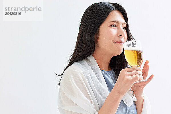 Japanese woman holding a glass of beer