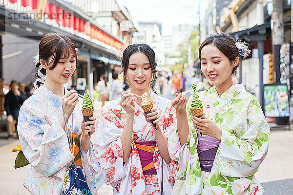 Japanese friends wearing yukata visiting traditional area in Tokyo