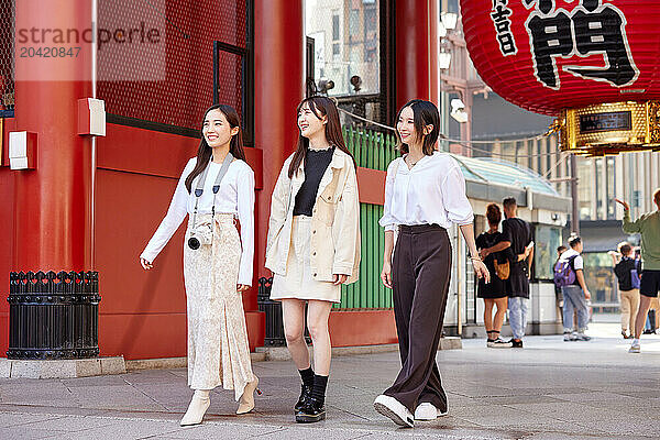 Japanese friends visiting traditional temple in Tokyo