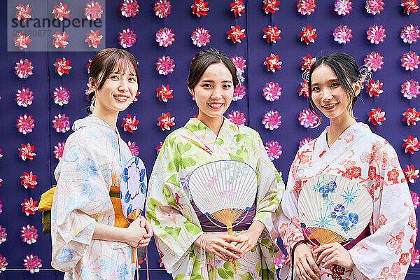 Japanese friends wearing yukata visiting traditional area in Tokyo