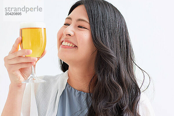 Japanese woman holding a glass of beer