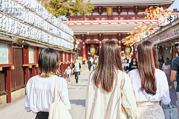 Japanese friends visiting traditional temple in Tokyo